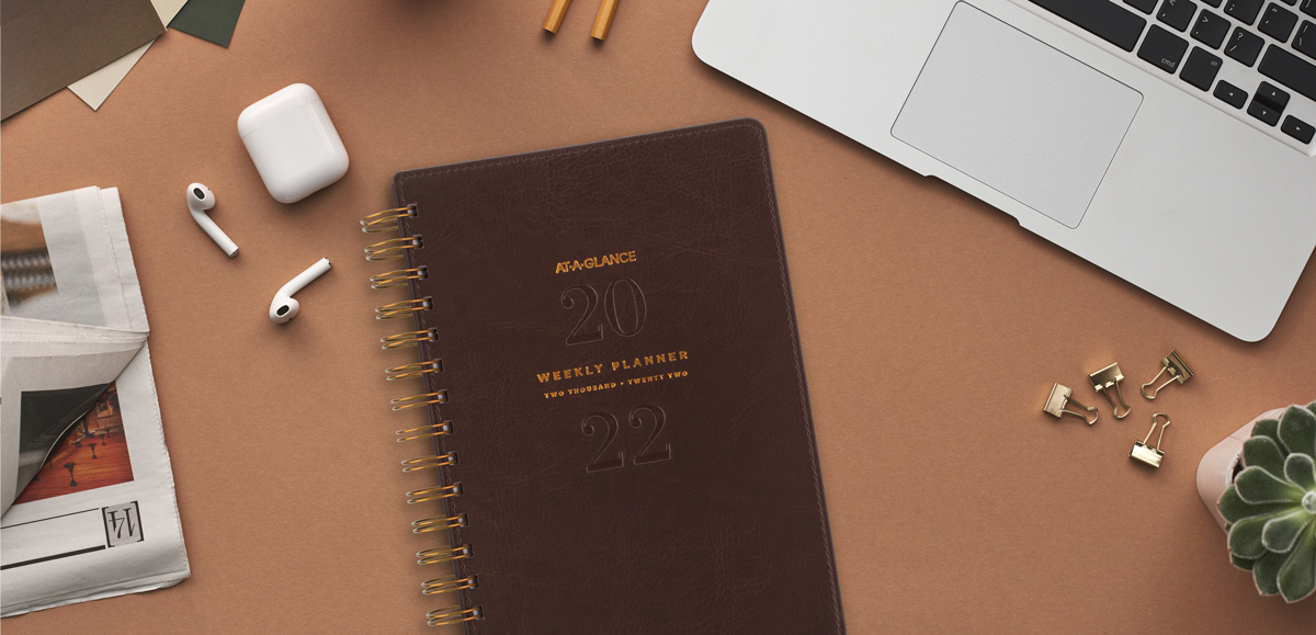 AT-A-GLANCE Signature Collection weekly planner on desk