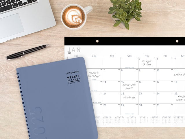Contemporary planner and desk calendar on simple desk setting