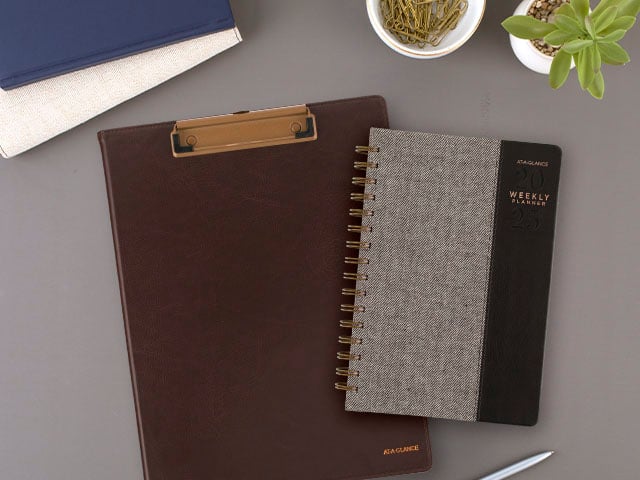 Signature clipfolio and planner on neutral desk setting