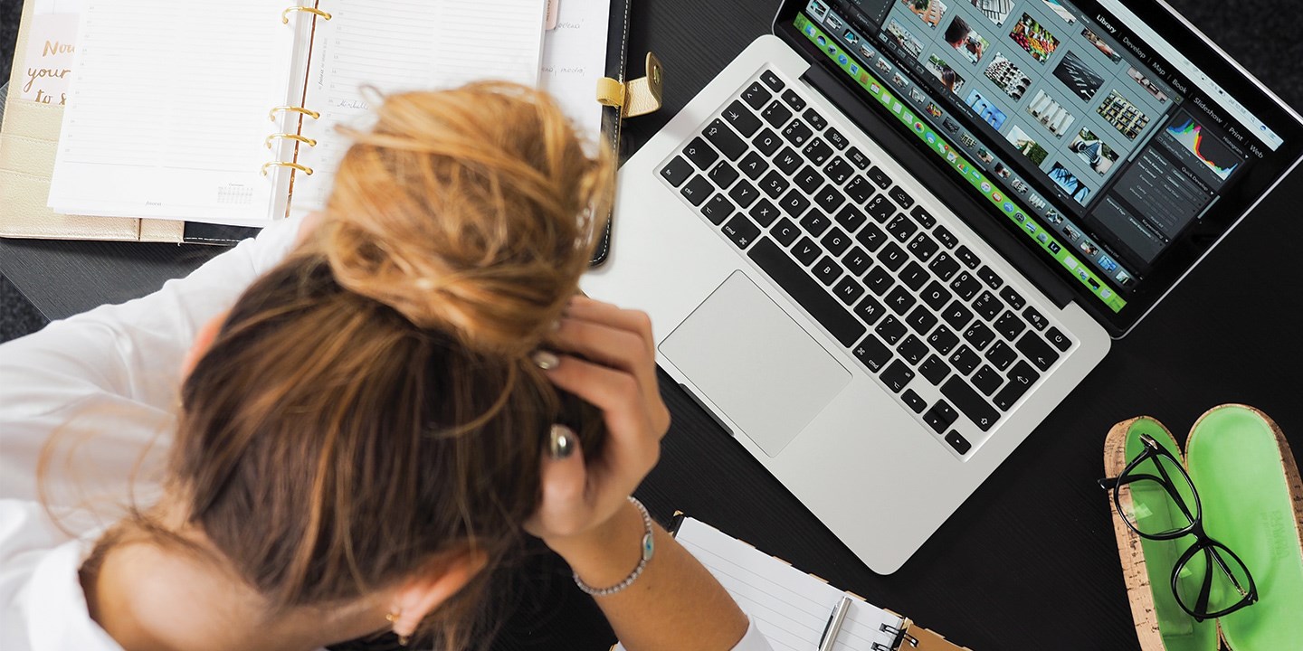 Top view of frustrated woman sitting at her laptop