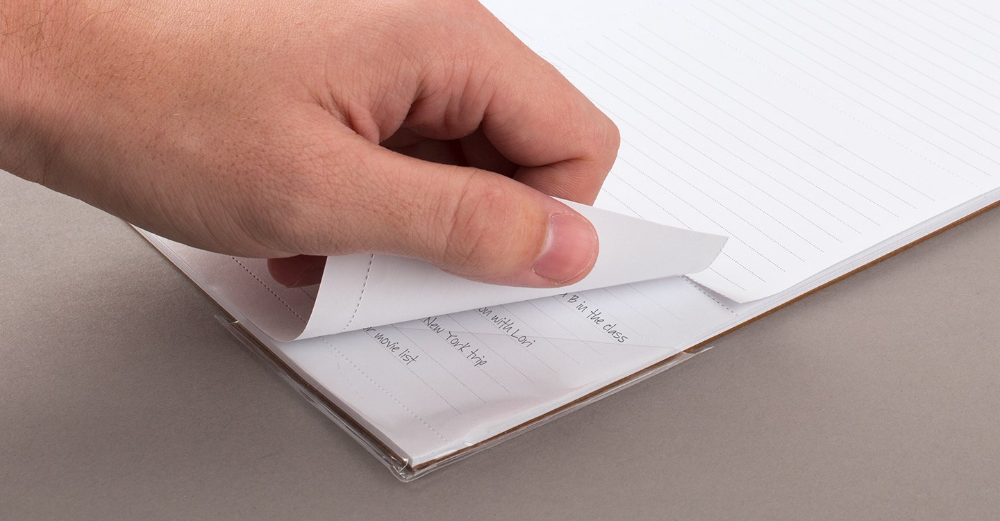 Person tearing off the bottom portion of a page from their calendar