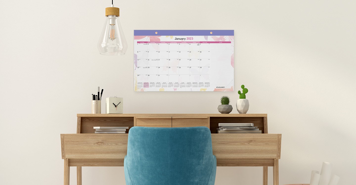 Desk pad calendar hung up on the wall of a home office